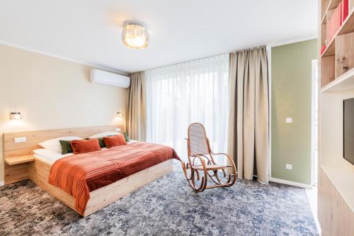 a hotel room with a bed and a chair at Hotel Zum Pfeiffer in Radebeul