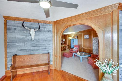a living room with a bench and a skull on the wall at Charming Farmington Home about 16 Mi to Aztec Ruins! in Farmington