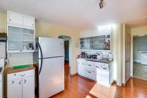 a kitchen with white cabinets and a refrigerator at Charming Farmington Home about 16 Mi to Aztec Ruins! in Farmington
