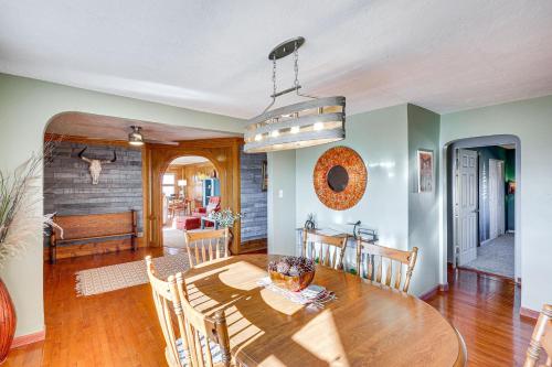 a kitchen and dining room with a wooden table at Charming Farmington Home about 16 Mi to Aztec Ruins! in Farmington