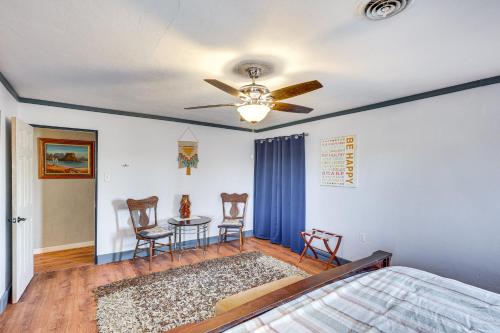 a bedroom with a ceiling fan and a table and chairs at Charming Farmington Home about 16 Mi to Aztec Ruins! in Farmington