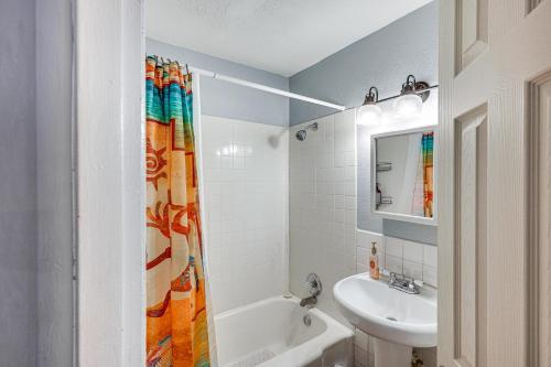 a bathroom with a sink and a shower curtain at Charming Farmington Home about 16 Mi to Aztec Ruins! in Farmington
