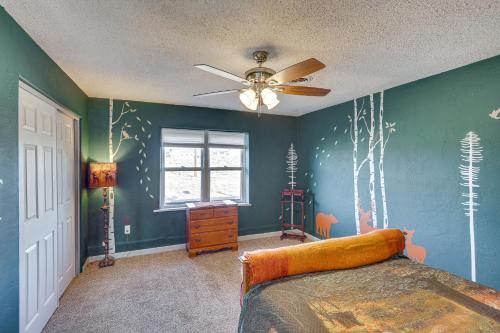 a bedroom with a bed and a ceiling fan at Charming Farmington Home about 16 Mi to Aztec Ruins! in Farmington