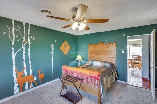 a bedroom with a bed and a ceiling fan at Charming Farmington Home about 16 Mi to Aztec Ruins! in Farmington