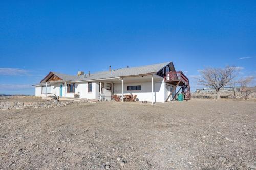a white house with a gravel driveway in front of it at Charming Farmington Home about 16 Mi to Aztec Ruins! in Farmington