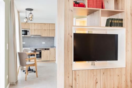 a living room with a flat screen tv on a wall at Hotel Zum Pfeiffer in Radebeul