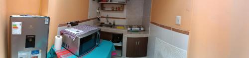 a small kitchen with a television in a room at Hospedaje Vacacional - Colca in Chivay