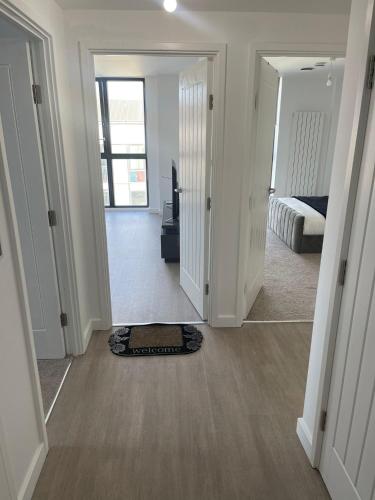 a hallway with a room with a bed and a mirror at New Luxury 2 Bedroom apartment with a beautiful London City view in Barking