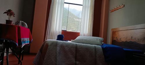 a bedroom with a table and a window at Hospedaje Vacacional - Colca in Chivay