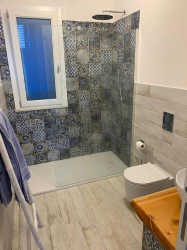 a bathroom with a shower and a toilet and a sink at Isola di Marettimo casa vacanze in Marettimo