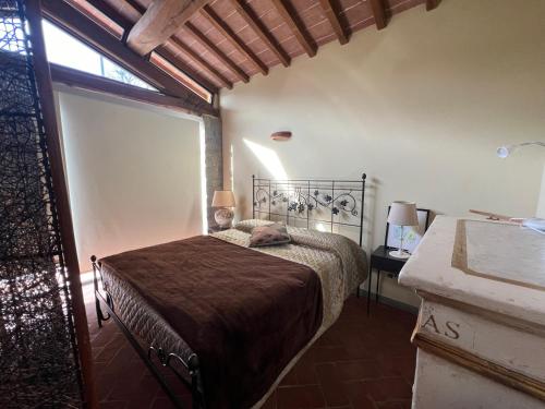 a bedroom with a bed in a room with a window at Villa Cerretina in Cerreto Guidi