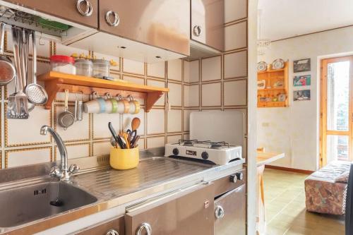 a kitchen with a sink and a stove at Monolocale incantevole con una vista panoramica in Filettino