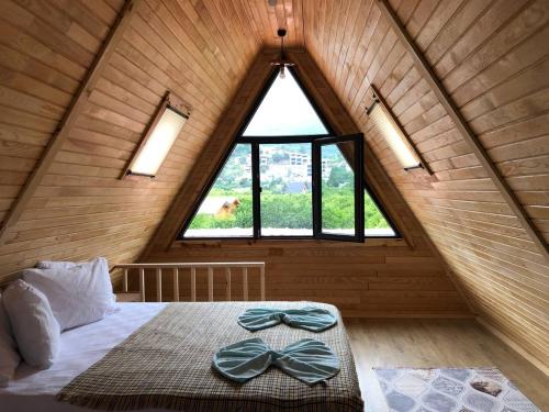 a bedroom with a bed with bow ties on it at Adrasan Twin Aparts in Kumluca
