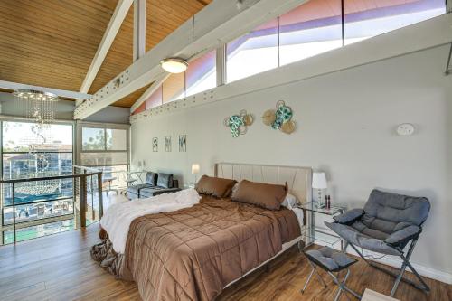 ein Schlafzimmer mit einem großen Bett und einem Stuhl in der Unterkunft Waterfront Long Beach Condo with Pool Access! in Long Beach