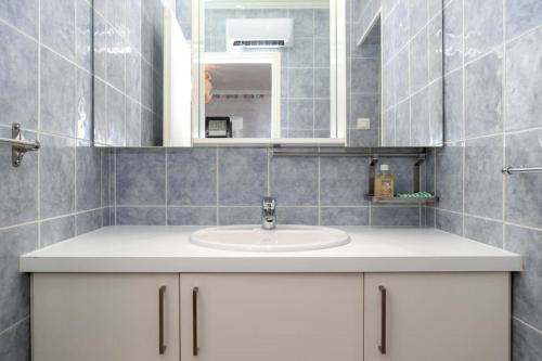 a bathroom with a sink and a mirror at Élégant appartement aux portes de paris in Saint-Ouen
