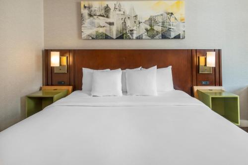 a bedroom with a large bed with two night stands at Comfort Inn East in Sudbury