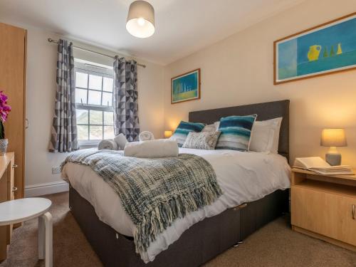 a bedroom with a large bed and a window at 3 Bed in Croyde 87752 in Croyde