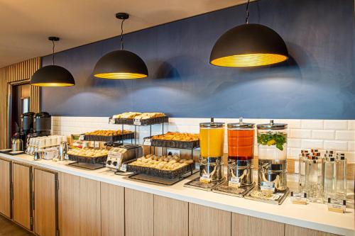 a buffet line with different types of food and drinks at Holiday Inn Express Paris-Canal De La Villette by IHG in Paris