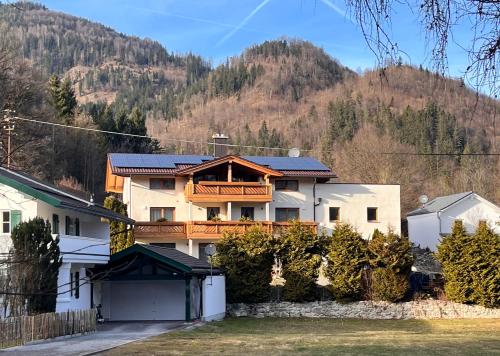 a house with a mountain in the background at Ferienwohnung Trissl in Oberaudorf