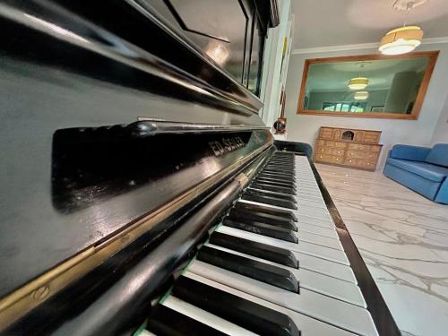 a close up of a piano in a living room at Villa Diana Exclusive Apartment in Taormina