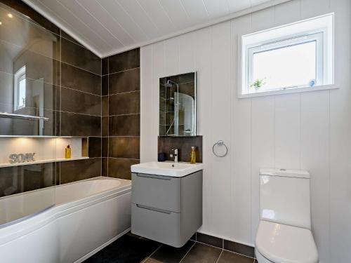 a bathroom with a sink and a tub and a toilet at 2 Bed in Castle Douglas 77838 in Auchencairn