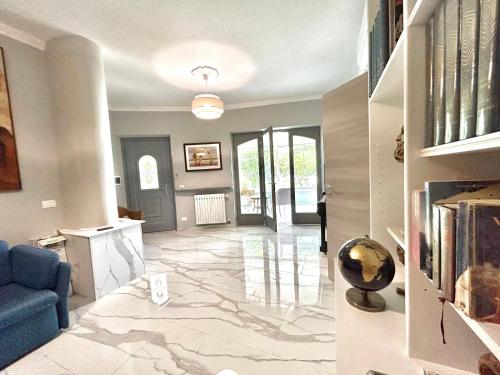 a living room with a blue couch and a marble floor at Villa Diana Exclusive Apartment in Taormina