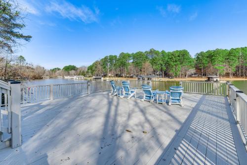 a group of chairs sitting on a deck next to the water at Littleton Home with On-Site Lake Gaston Access! in Littleton