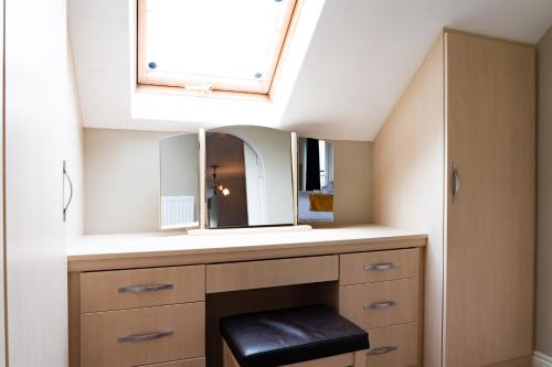 a bathroom with a sink and a mirror at Entire 4 Bed Cosy Luxury Spacious house in Huntingdon