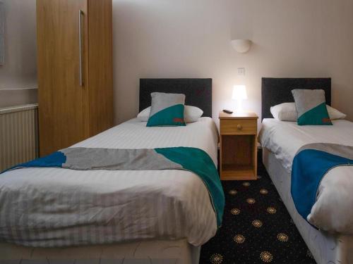 Säng eller sängar i ett rum på Knowesgate Hotel B&B