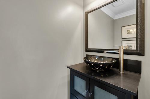 a bathroom with a sink and a mirror at Luxury 4BR - Free Parking - 10 Minutes to Downtown in Toronto