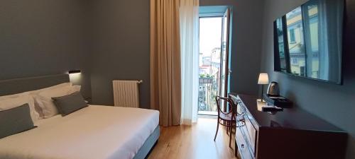 a bedroom with a bed and a window with a view at Deluxe Spaccanapoli in Naples