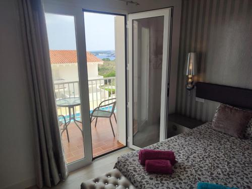 a bedroom with a bed and a balcony with a view at Des Artistes Son Parc in Son Parc