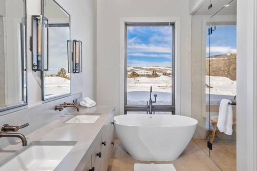 a white bathroom with two sinks and a large window at Silverpick Ranch - adventure & luxury in Telluride in Telluride
