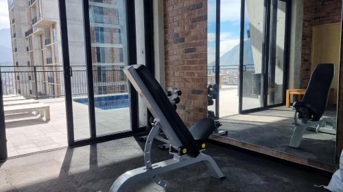 a gym with a tread machine in front of a window at Depto Centro de Monterrey by tuhost in Monterrey
