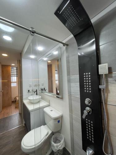 a bathroom with a toilet and a sink and a shower at Apto excelente Ubicación Bogotá in Bogotá