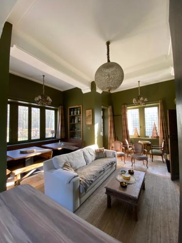 un salon avec un canapé et une table dans l'établissement le Pavillon d'Hermières, proche Disneyland Paris, à Favières