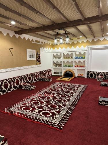 a room with a large rug on the floor at منتجع لامة مدر in Al Wudayy