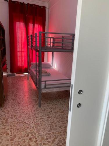 a bedroom with two bunk beds with red curtains at Gargano Home in Vieste