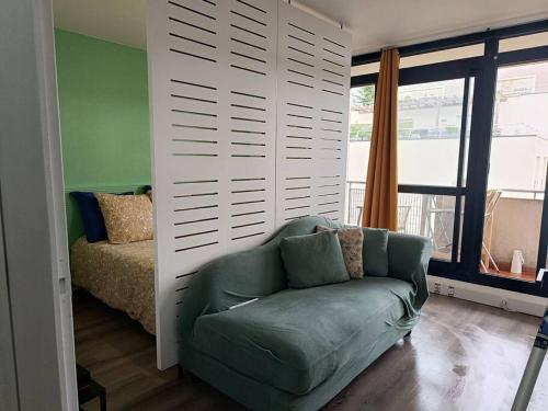 a room with a couch and a bed and a window at Appartement avec vue sur le lac in Lognes