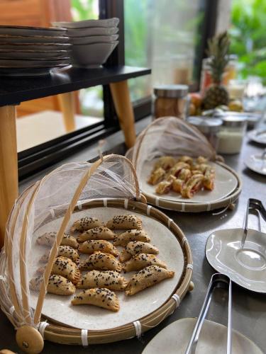 a table topped with plates of food on top at Pousada Baobá in Jericoacoara