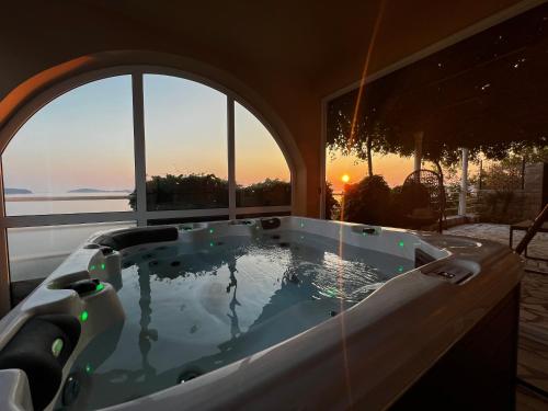 a jacuzzi tub in a room with a view at Holiday Apartment Lira jacuzzi - sea view- terrace in Mlini