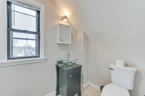 a bathroom with a toilet and a window at Pet-Friendly Malden Apartment 7 Mi to Boston! in Malden