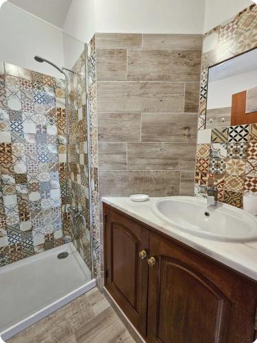a bathroom with a sink and a shower and a tub at Casa Albufeira in Albufeira