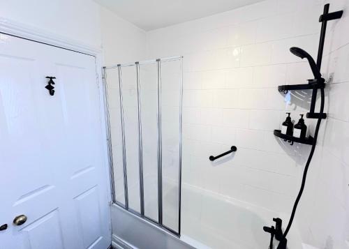 a bathroom with a shower with a glass door at Stunning 1-Bedroom House in Crystal Palace London in London