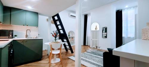 a kitchen with a ladder in the middle of a room at 4 couchages Front de Mer Clim Parking privatif Wifi in Nice