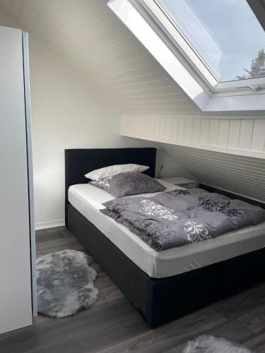 a bedroom with a bed with a skylight at Central Ferienwohnung in Bad Saulgau