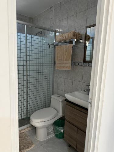 a bathroom with a toilet and a sink and a shower at Apto comodo, muy cerca de playa 101 in Mazatlán