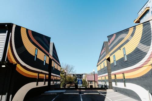 a pair of buildings with colorful paint on them at The Vinyl at Music Row - 1 Bedroom Apartment in Nashville