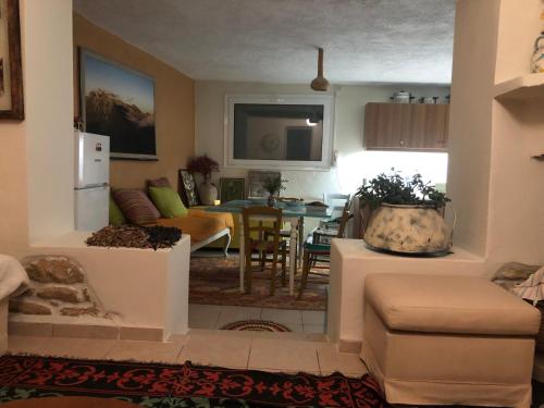 a living room with a kitchen and a dining room at Elol stone house in Lithínai