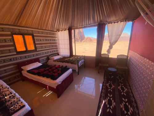 an aerial view of a room with beds and a window at Authentic Wadi Rum camp & tours in Wadi Rum